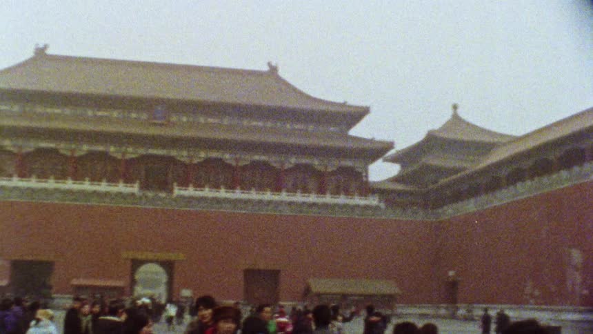 Tourists walking by a temple on the great wall of china on a cloudy day