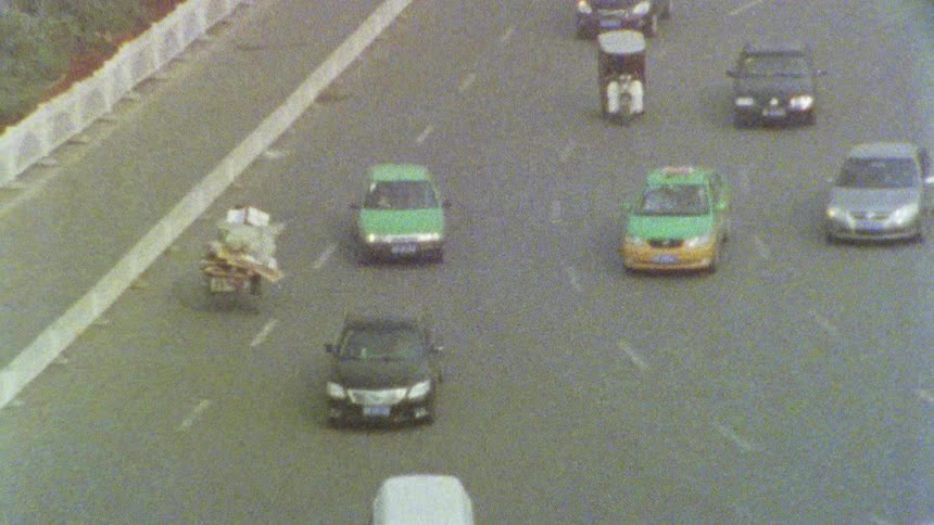 Top view with a bus and cars traveling on a highway