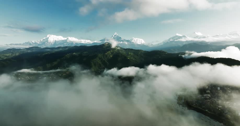 Aerial panorama of bay with forested and snowy mountains on the horizon