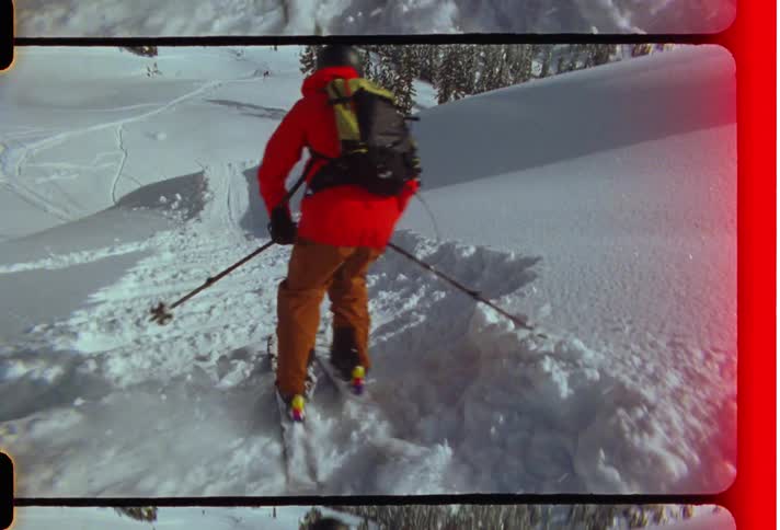 Person skiing down a snow covered mountain