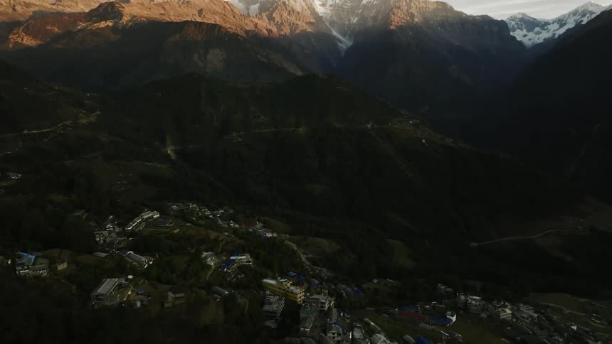 Aerial panorama of a village amidst the mountains