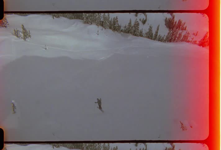 Man skiing in the snow and jumping off a big mountain