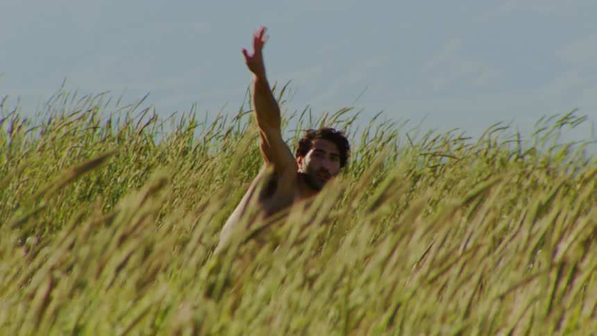 Man without a shirt in the middle of the woods in an openair natural environment dancing