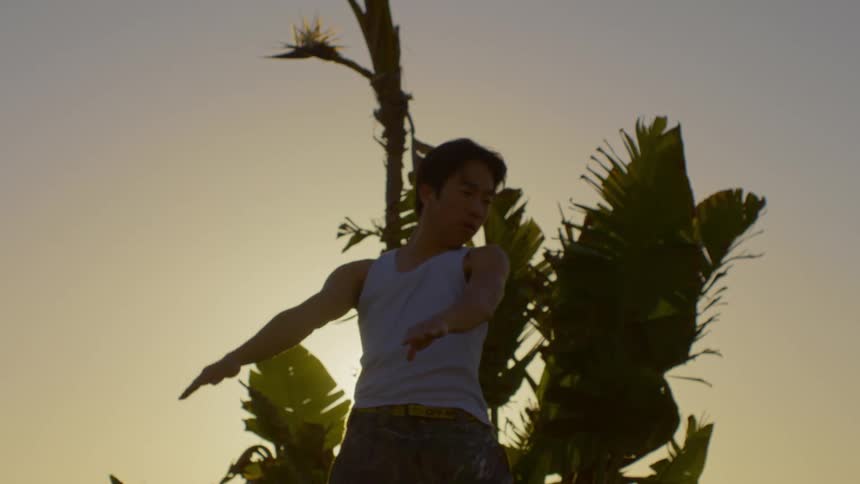 A man is dancing at sunrise