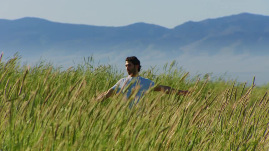A clip of a man stretching in the bush