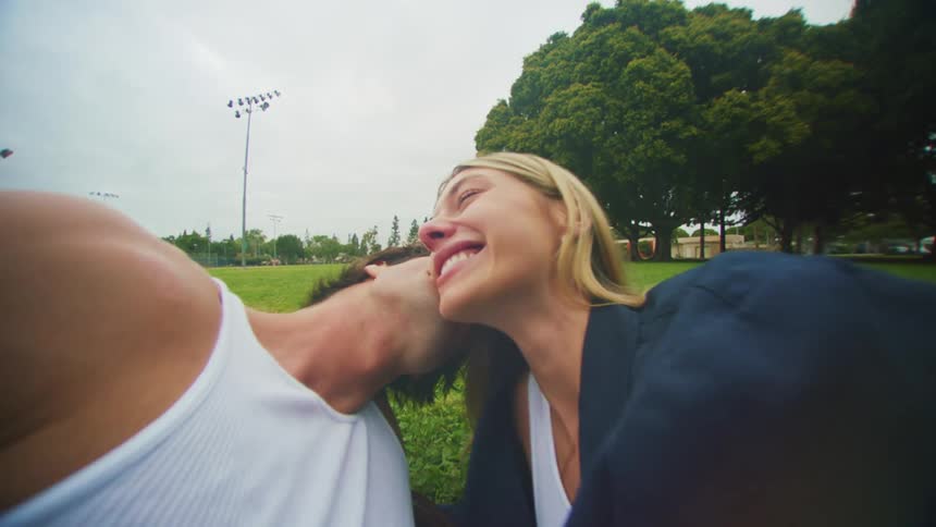 A couple kiss in the park