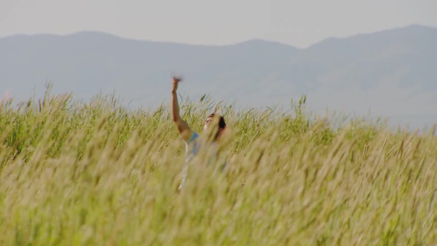 A man is dancing in the tall grass