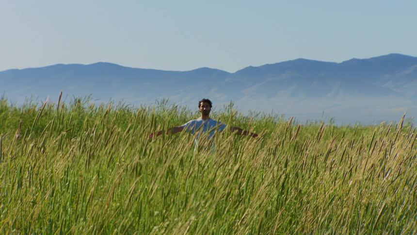 Man in a natural environment raising his arms