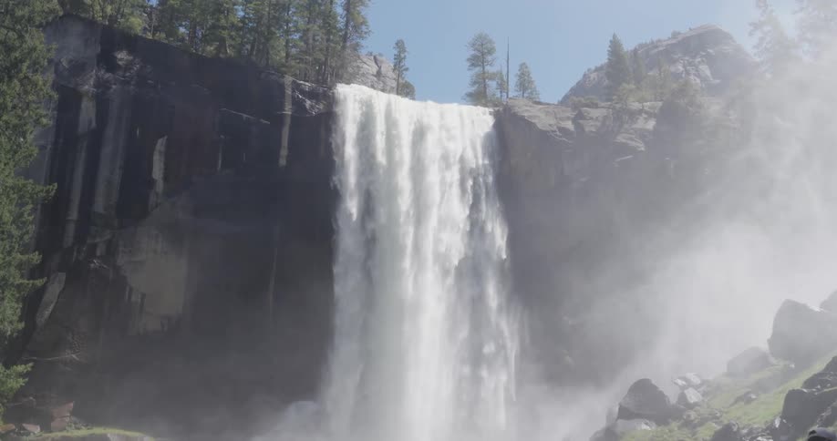 Landscape of a freefalling waterfall with vegetation around