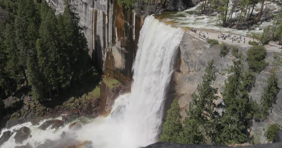 The waterfall is crashing on the rocks below