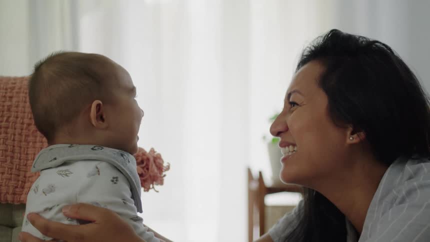 A mother is talking with her baby