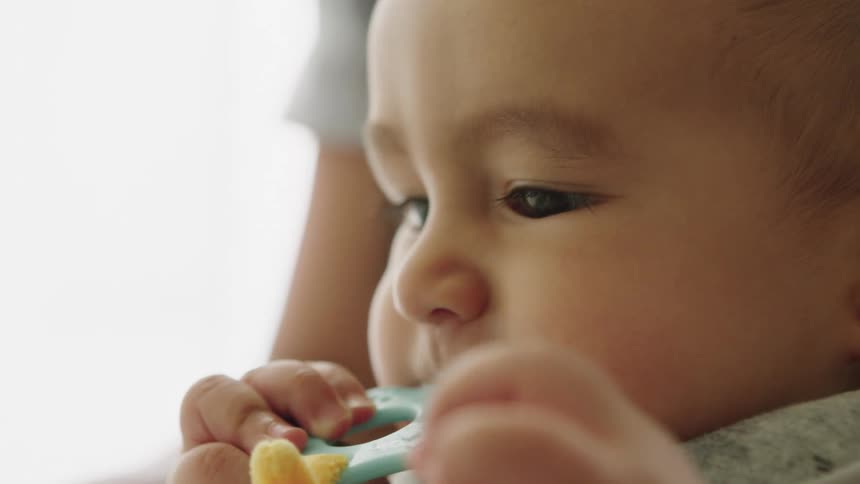 Cloes up of a baby sucking a pacifier