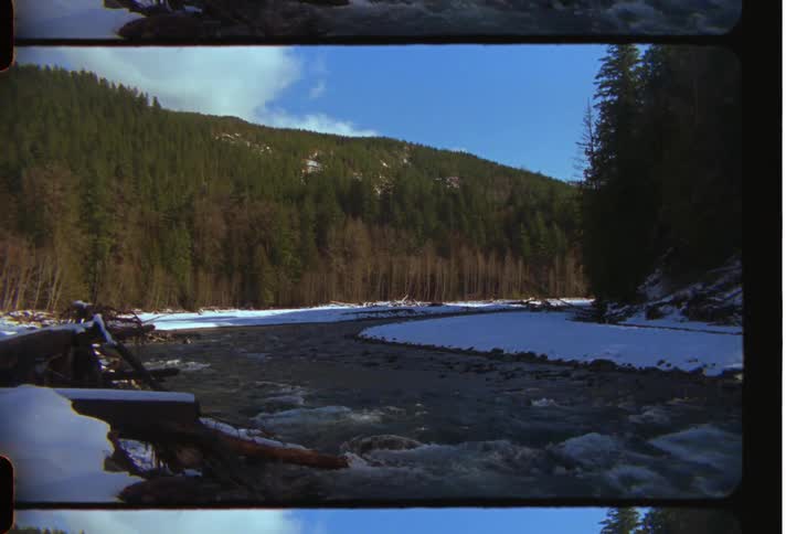 A mountainous landscape with a river flowing through it