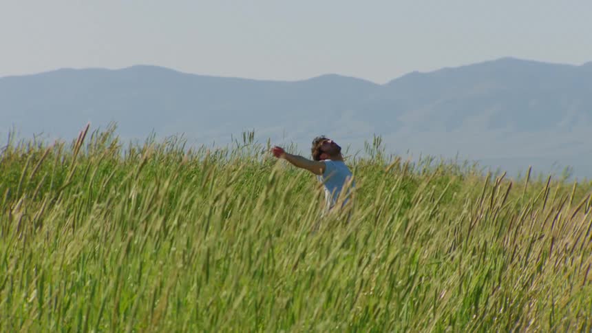 Man dancing on a mountain in the middle of the woods