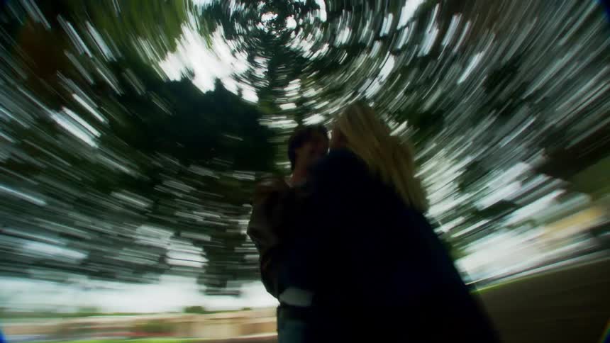 A couple are hugging under the tree