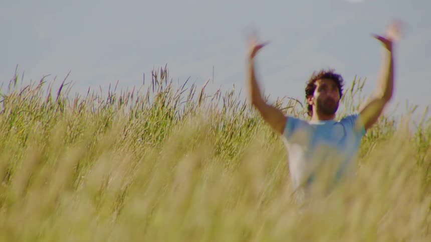 A man is dancing in the grass