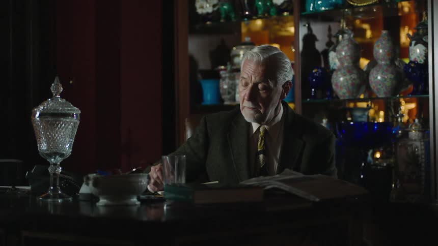 Old man writing at a desk