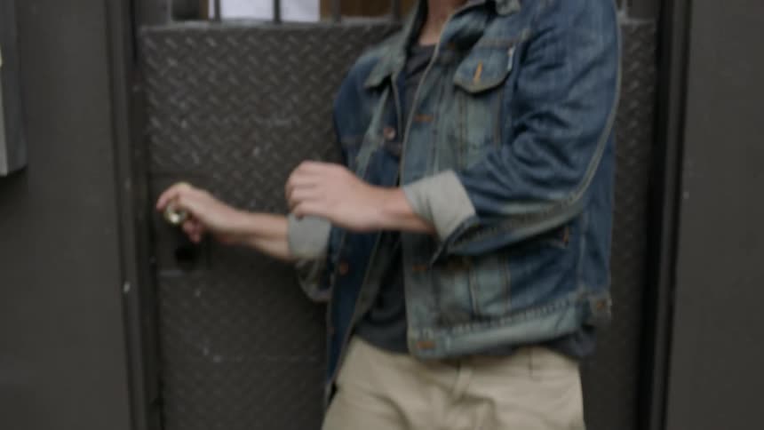 A man is standing on a stoop fearful of falling antiques