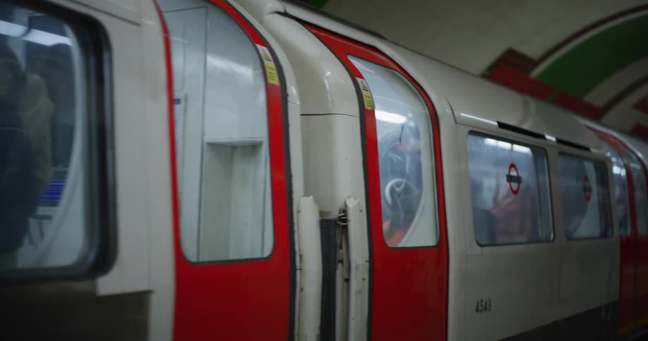 Train loaded with people stopping at an underground station