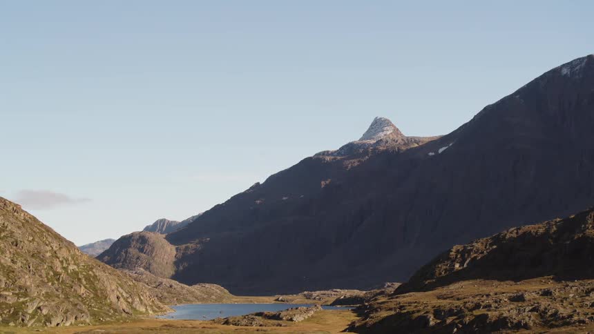 A small lake is by the mountains