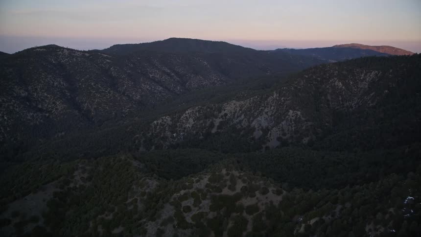 The mountains are covered in shade at sunrise