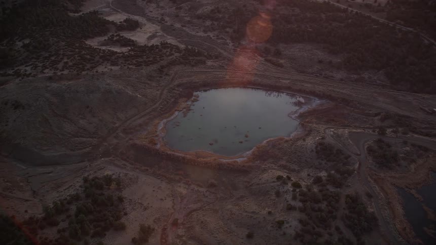 A small lake in hilly terrain