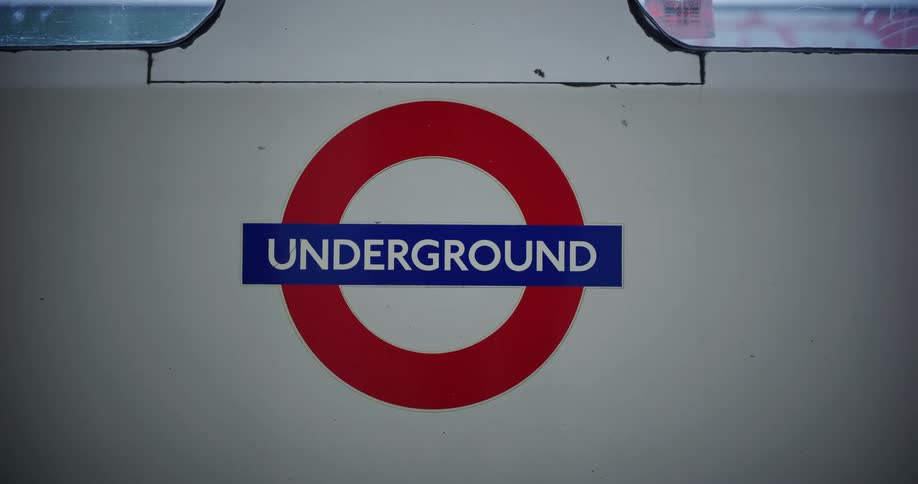 The london underground logo on the side of a subway train