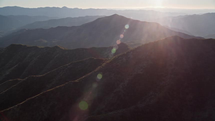 Aerial landscape of mountain range with reflection of morning sunlight