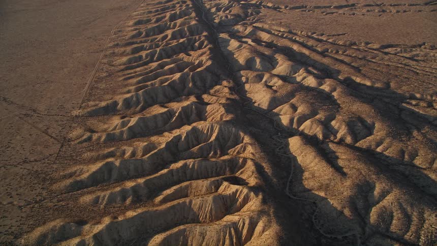 Aerial and natural scenery of hills with deformations in a desert environment