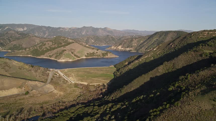 A mountain range with a river running through the valley
