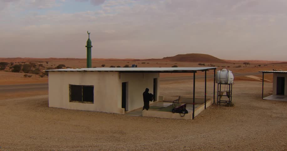 A person walks to the shelter in the desert