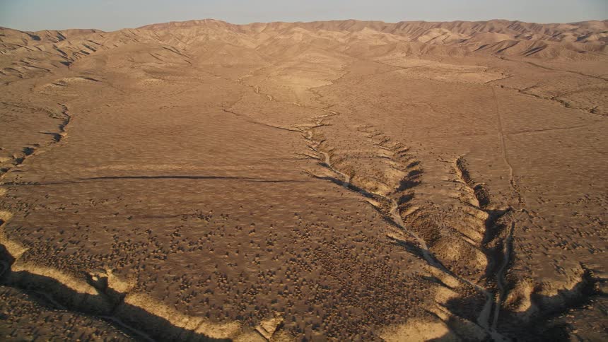 Aerial view of a desert terrain with hills and mountains