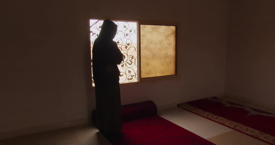 A man performs the salat in a mosque