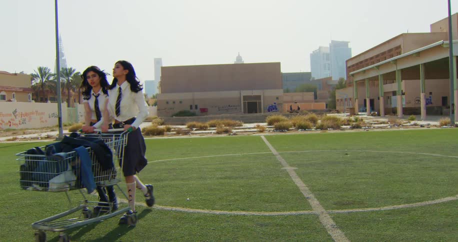 A clip of two female teenagers walking on the field