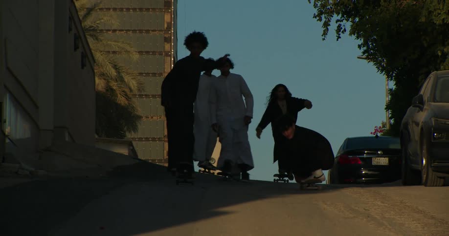 Muslim skateboarders on a city street