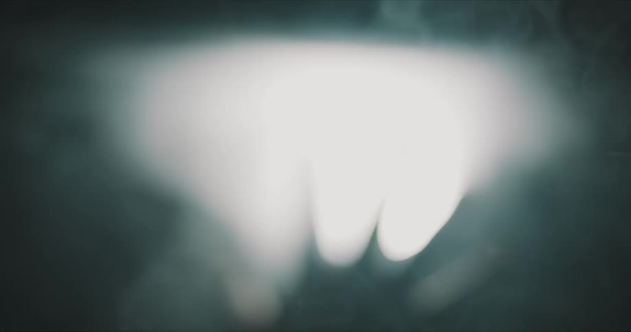 A trio of flashing white lights against a dark background