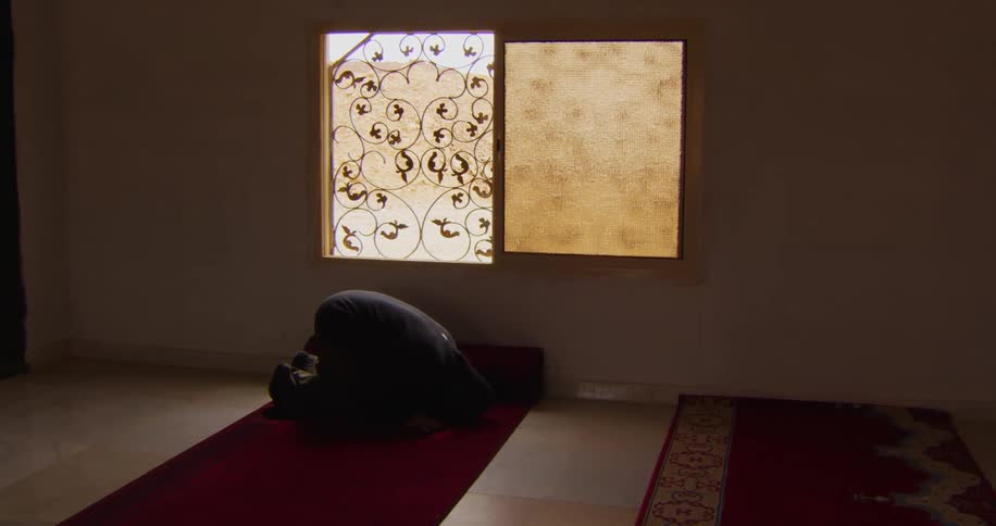 A man worships in prayer inside a mosque