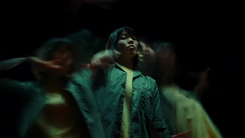 An asian woman dancing superimposed over her slowly moving