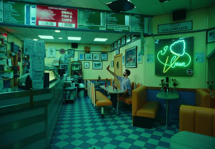 Man sitting in a diner takes a selfie