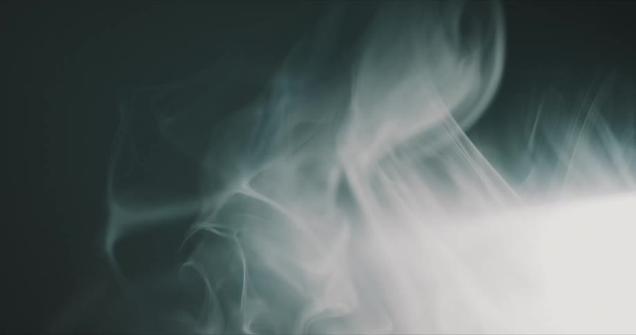 The light flickers in the smoke