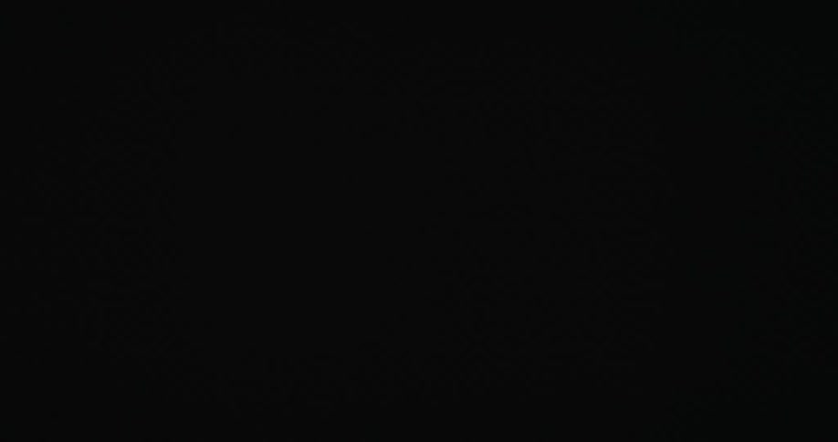Scattered diffuse triangular shapes floating against a dark background