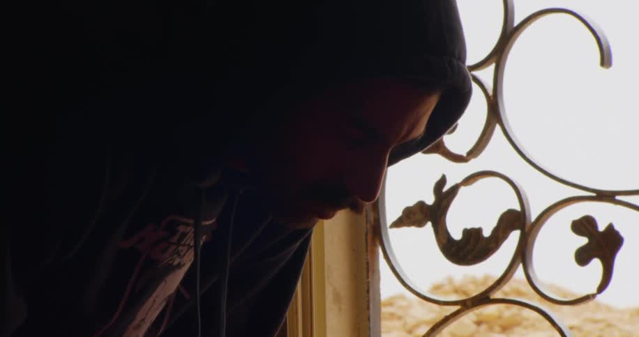 Portrait of a man in an indoor space saying his prayer