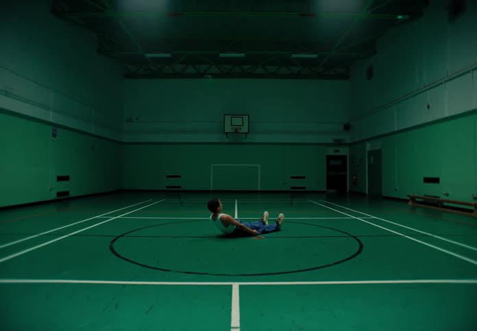 A person stretches inside a gym