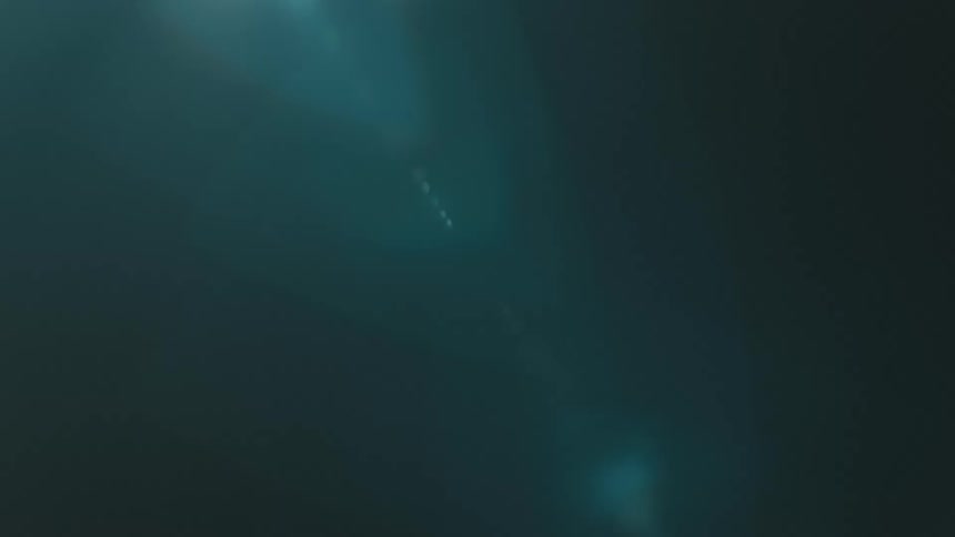 A dark background with a soft blue light beam crossing diagonally