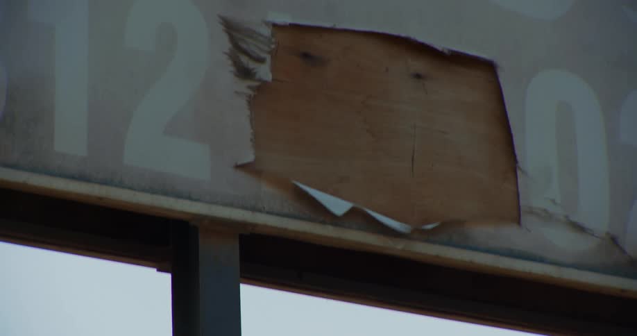 The wind blows the rotting sign