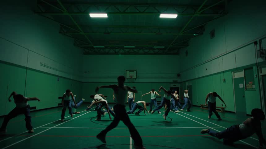 Overlay of a man dancing in many places across a gym at the same time