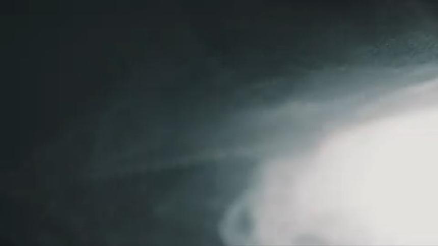 A cloud of smoke flashes in the darkness