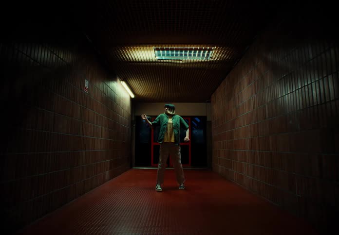 Woman dancing artistically while in a hallway at night