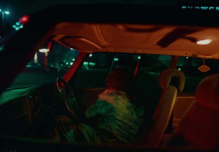 Woman getting out of her parked car at night