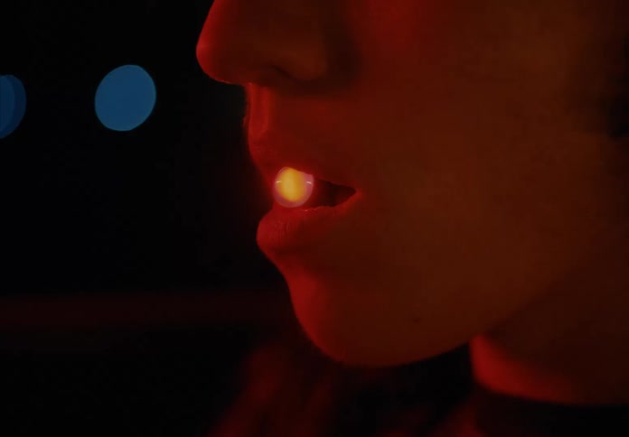 Colorful and abstract ball entering a persons mouth